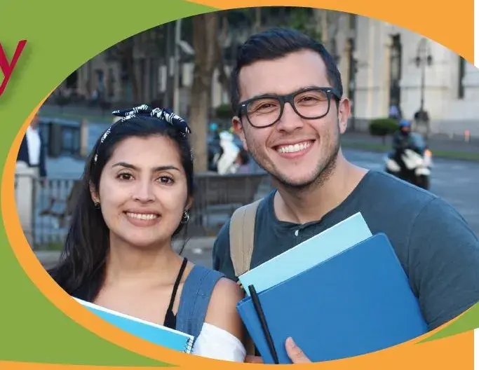 Two students holding books and smiling, framed in an apple-shaped crop