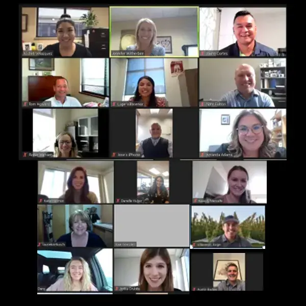 About twenty people gathered in a grid on a video call