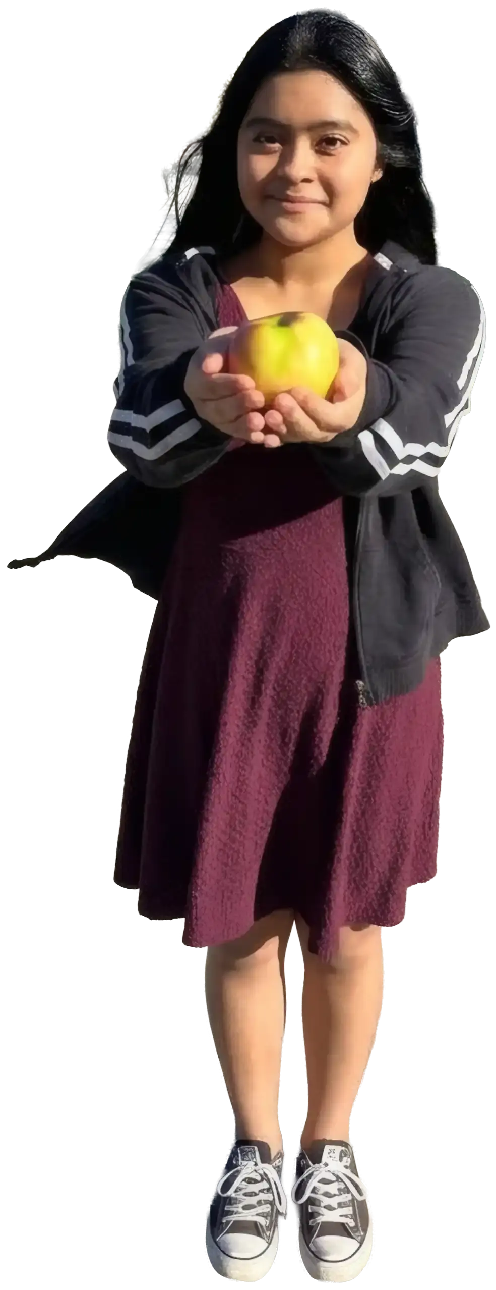 A WAEF student holding out a yellow apple in both hands