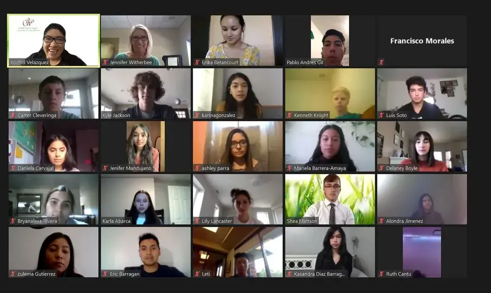 About twenty-five people gathered in a grid on a video call